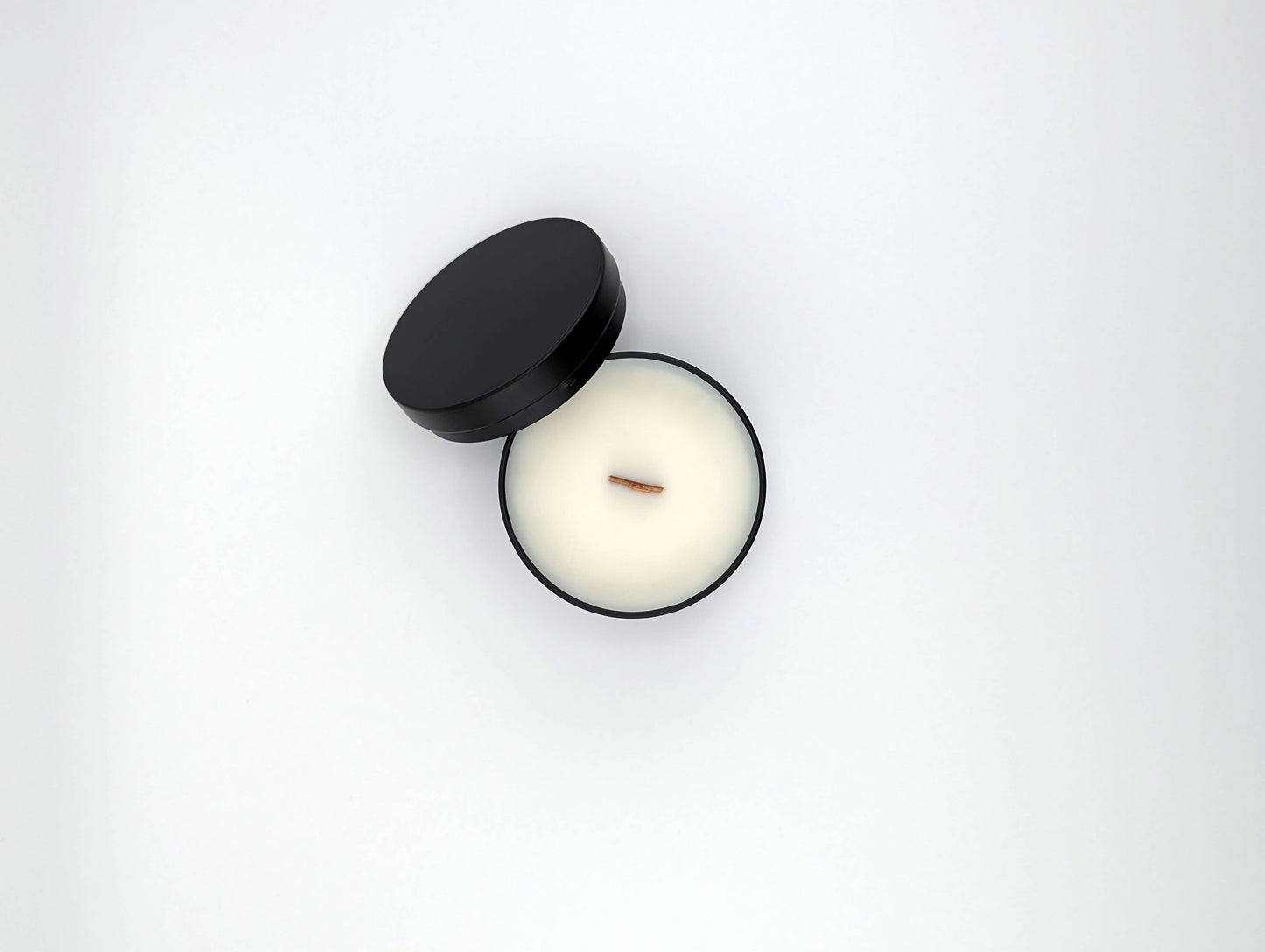 Candle in a black container on a white background