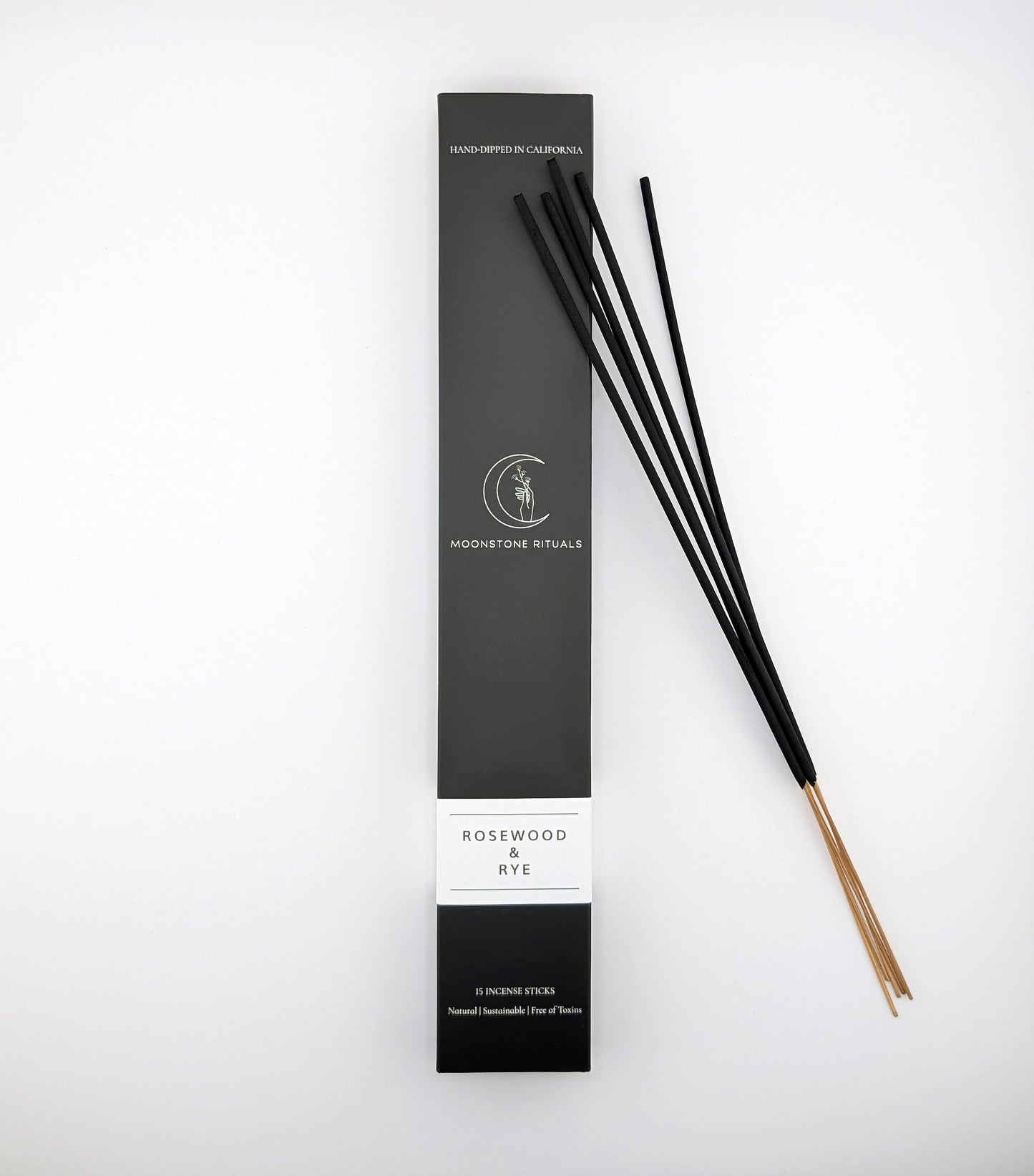 Black incense sticks with packaging on a white background