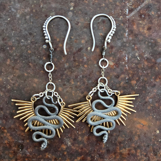 Brass and sterling silver earrings with undulating snake design and radiating sunburst spikes