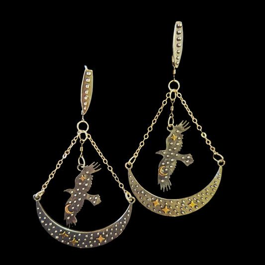 Sterling silver raven earrings with brass stars and crescent moons, double-swivel design.