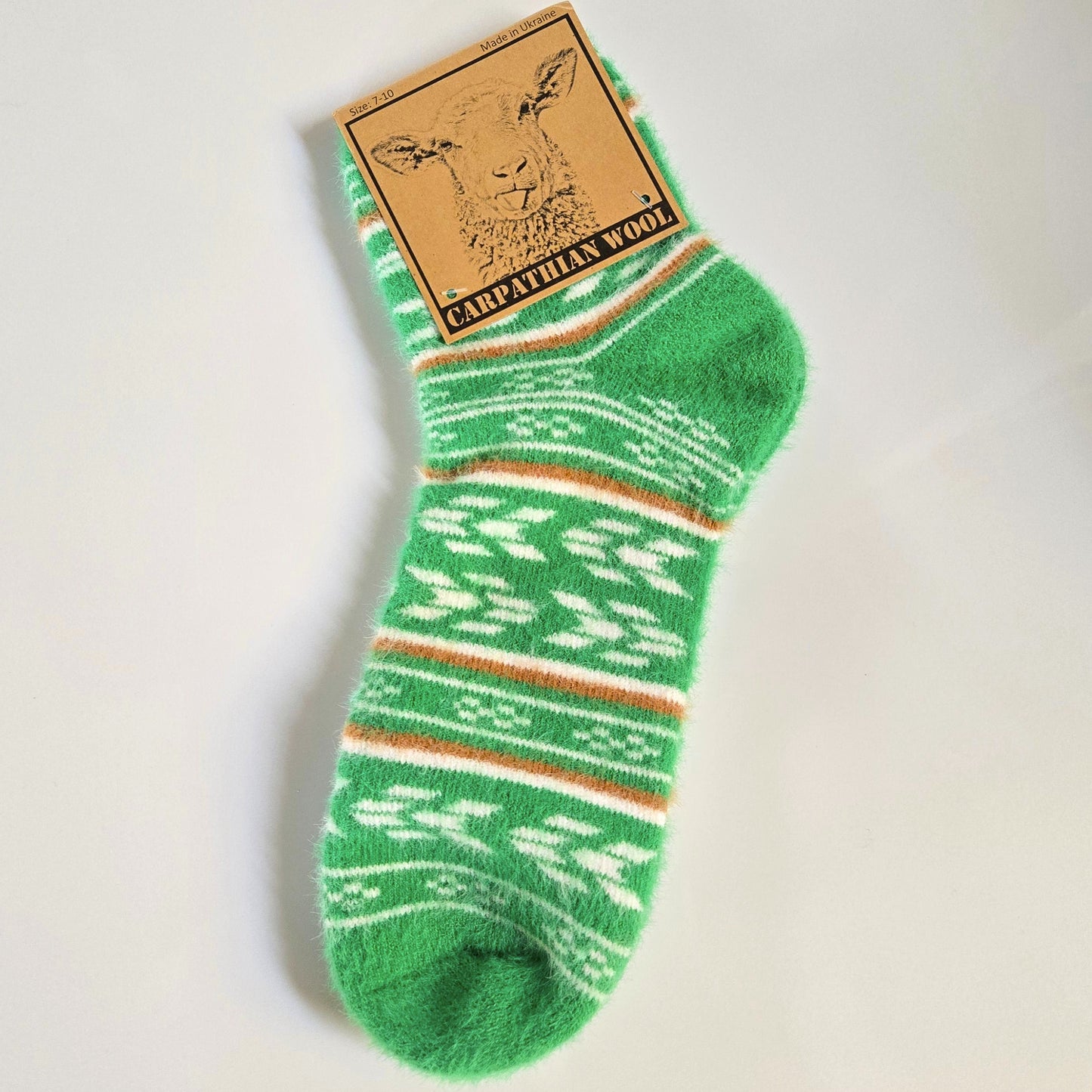 Green patterned sock with a cardboard label on a light gray background